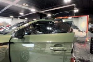 green car applying window tinting rival auto protection services pottstown pa
