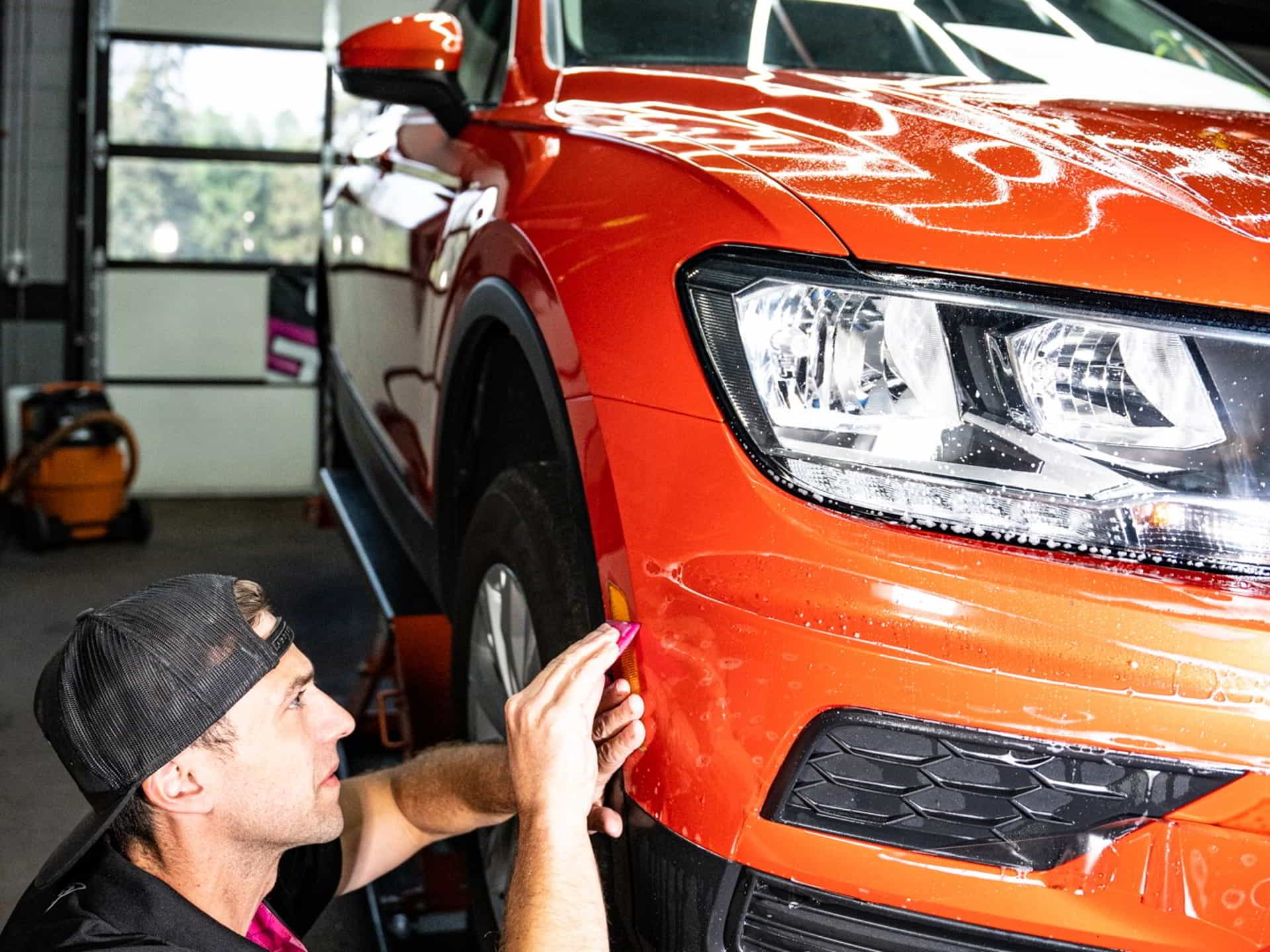 orange car bumper applying paint protection film rival auto protection services pottstown pa
