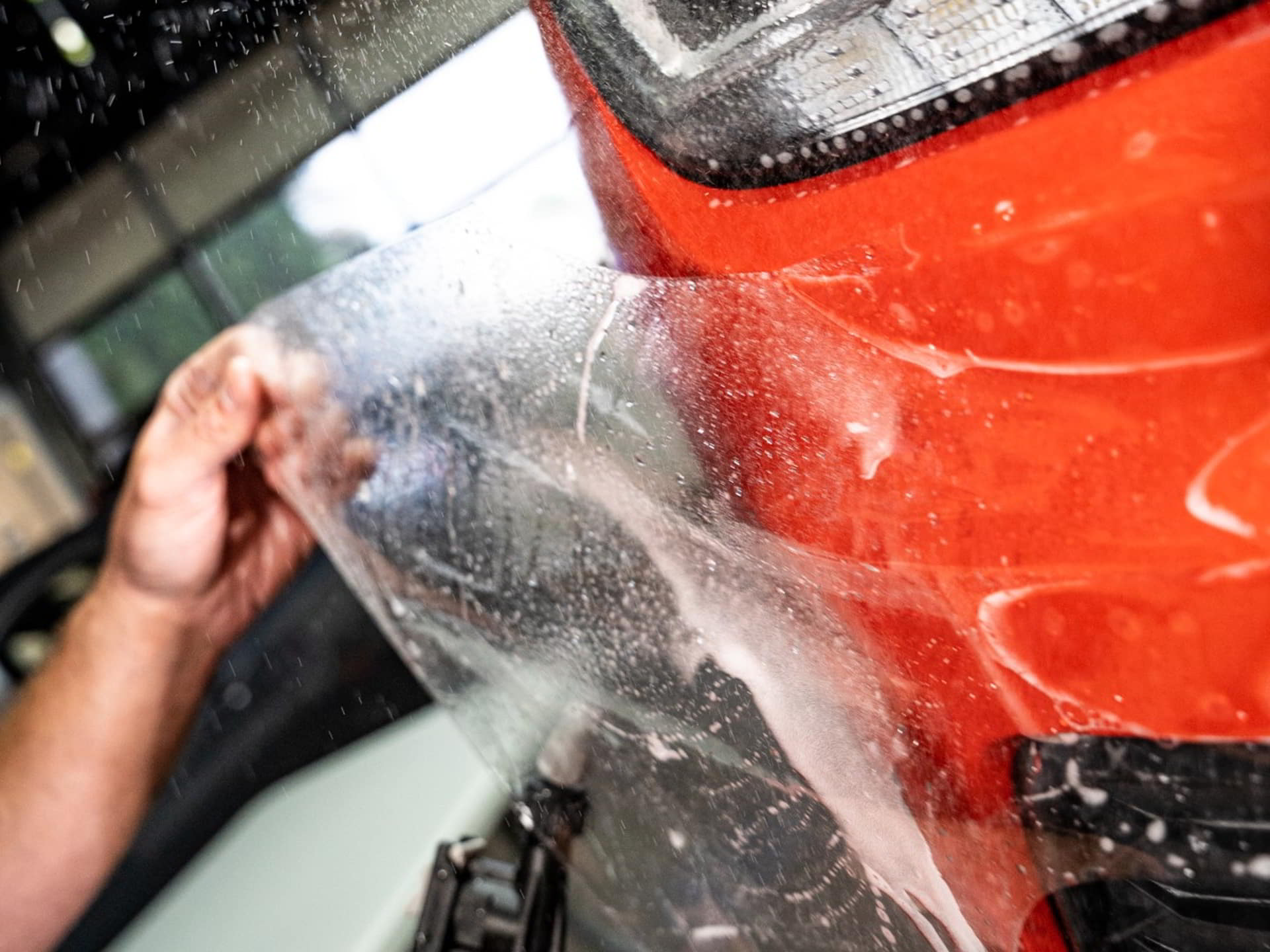 orange car head applying paint protection film rival auto protection services pottstown pa